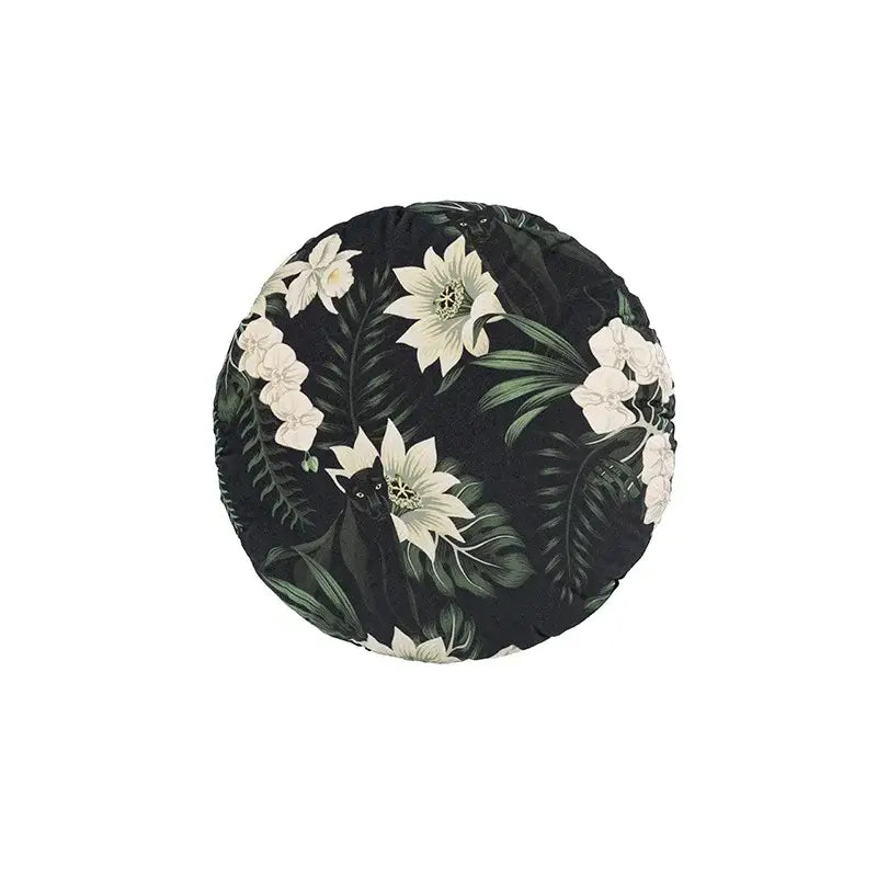 Black circular premium cushion cover with green jungle floral pattern featuring white orchids for living room decor