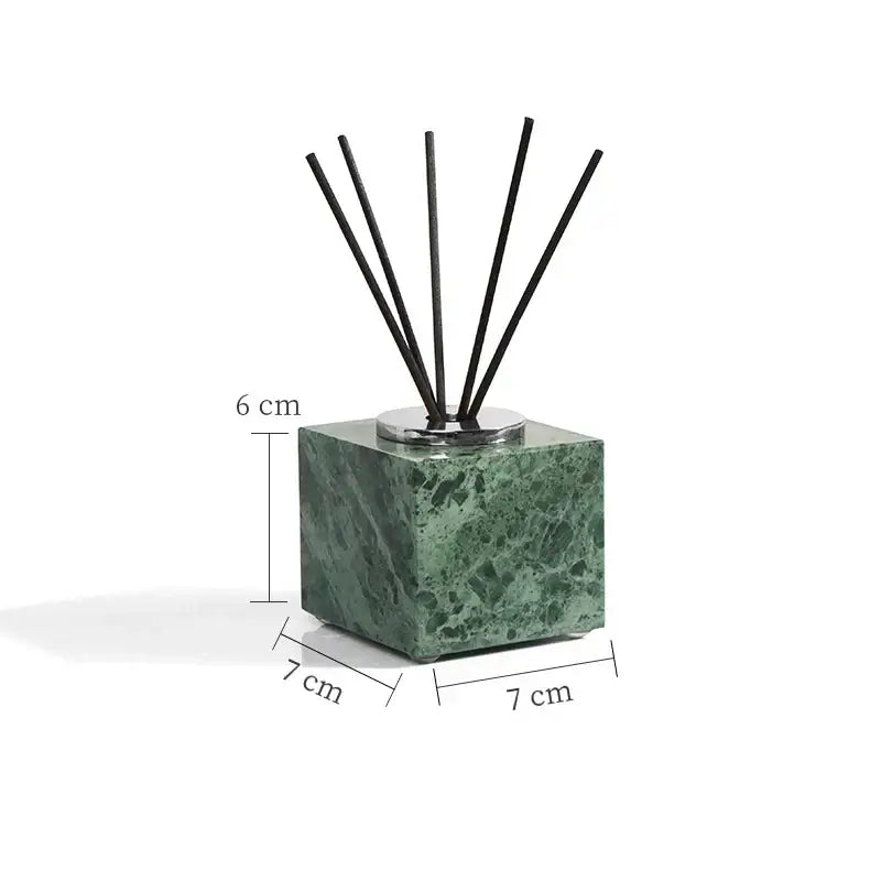 Green marble bathroom diffuser cube with black reed sticks and silver metal base from marble bathroom set with gold accents