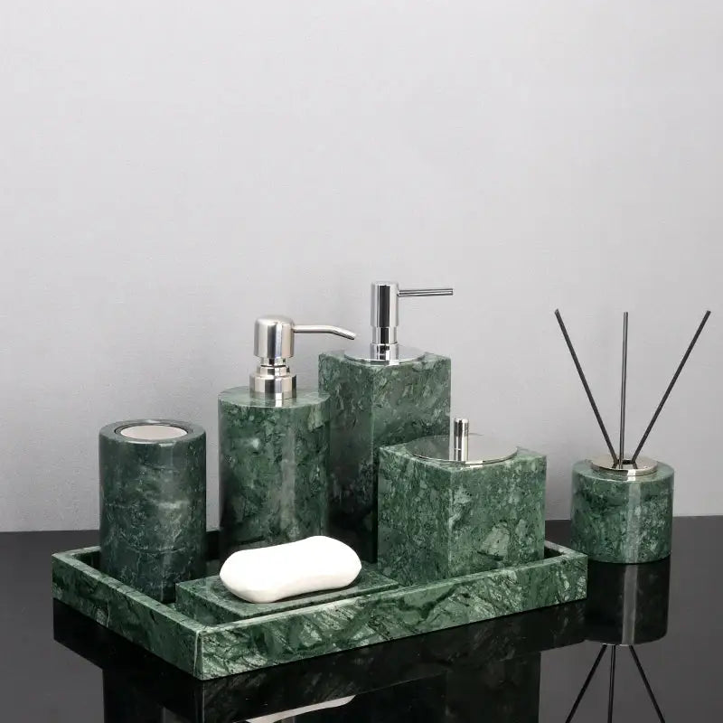 Green marble bathroom set with gold accents featuring sleek silver-tone pump dispensers and matching tray for accessories