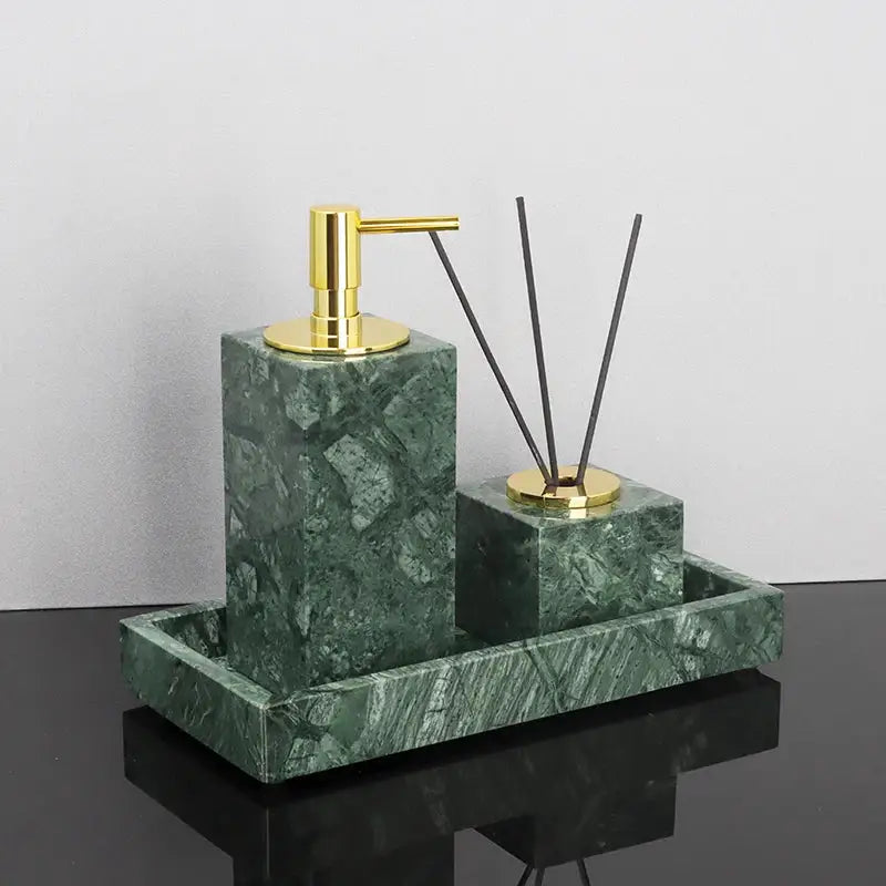 Green marble bathroom set featuring a marble soap dispenser and diffuser with gold accents on a coordinating tray