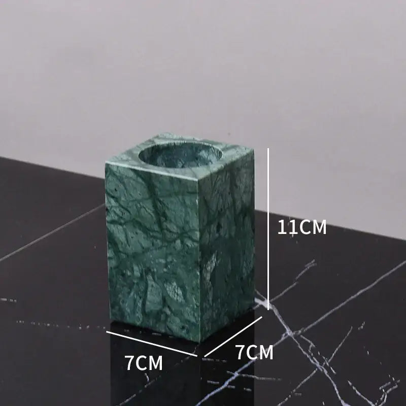 Green marble bathroom square candle holder with polished surface and natural veining in marble bathroom set with gold accents
