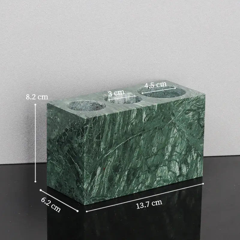Green marble vase with three circular openings measuring 3 cm 4.5 cm and 8.2 cm from a marble bathroom set with gold accents