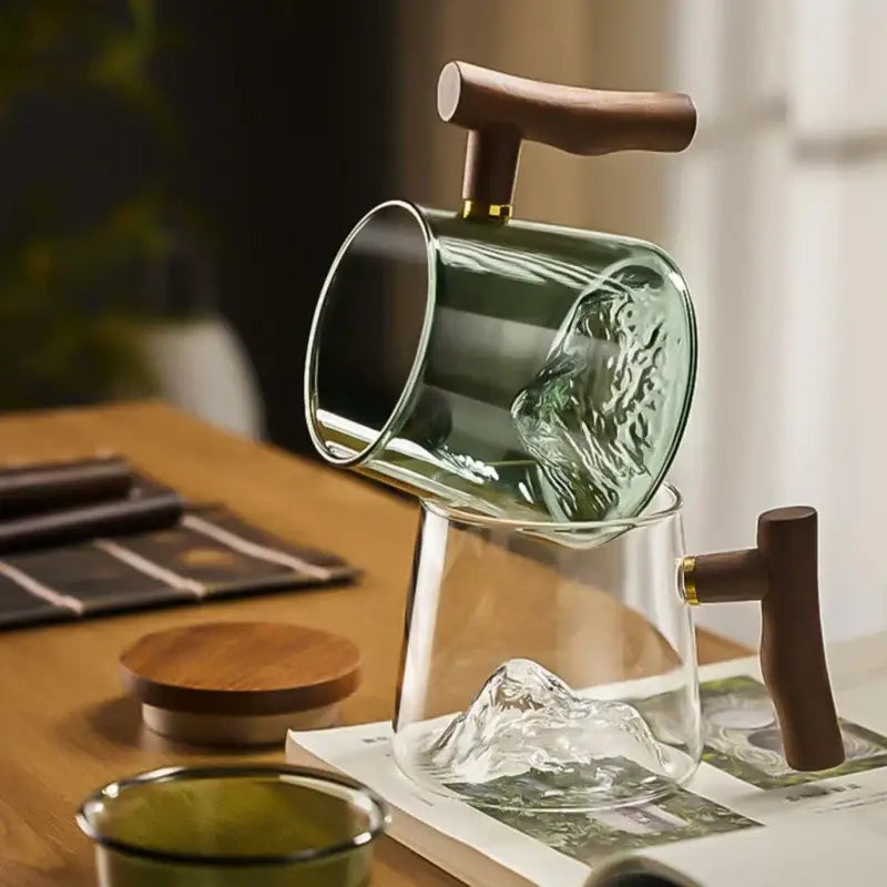 A sleek translucent green textured glass tea cup set with dark wood handles ideal for decorbites glass tea use