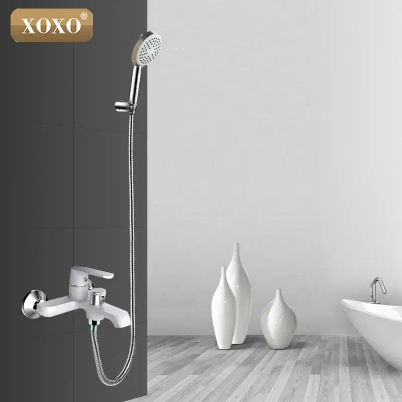 Xoxo brand chrome shower faucet set with handheld head in green and orange, mounted on a white faucet assembly