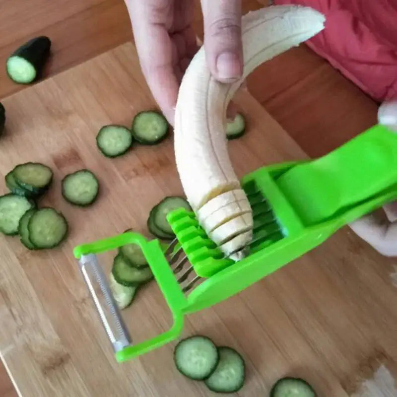 Bright green plastic 2-in-1 peeler slicer with metal blade slicing a peeled banana into uniform rounds