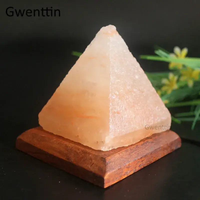 A peach-hued translucent crystal usb salt night light with natural texture on a rustic wooden base for decorbites bedroom decor