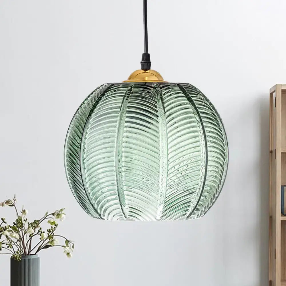 Green ribbed glass pumpkin pendant lamp with leaf pattern and gold fixture for dining room lighting