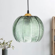 Green ribbed glass pumpkin pendant lamp with leaf pattern and gold fixture for dining room lighting