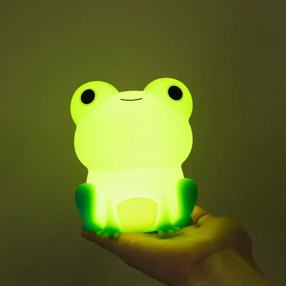 Green silicone frog night light made of smooth plastic with black eyes and a simple smile for bedroom decorbites frog night