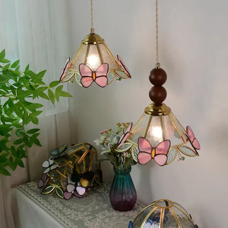 Pink butterfly-themed stained glass pendant light with gold-toned brass accents for bedroom decorbites clear glass led