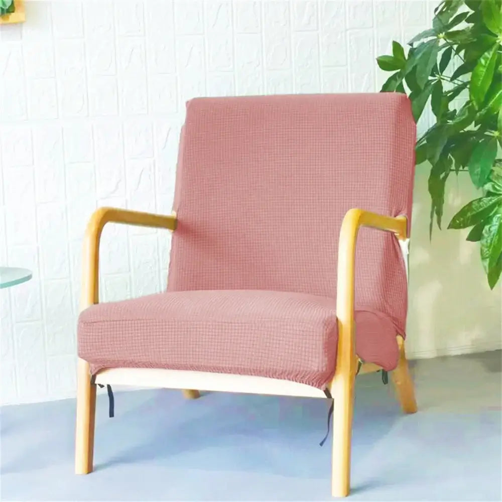 A pink jacquard elastic seat cover snugly fitted over a wooden armchair perfect as decorbites seat covers