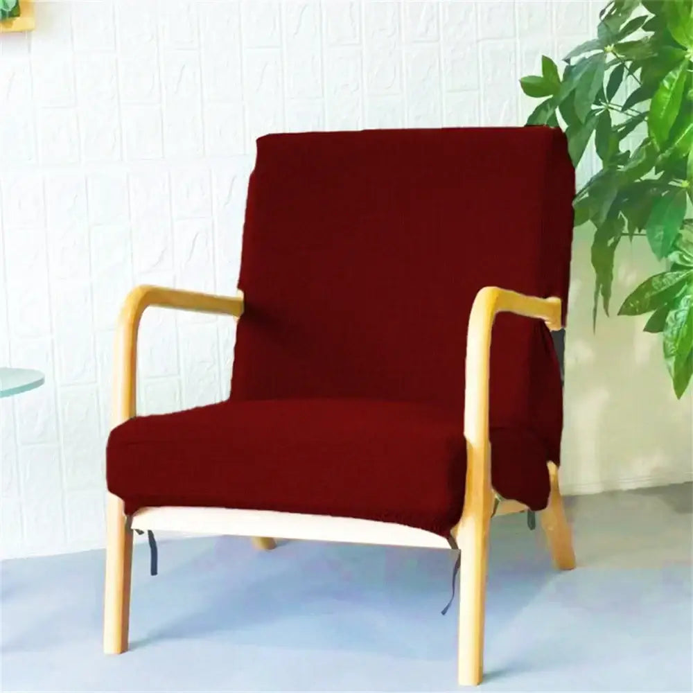 A cozy burgundy fabric chair cover snugly fitted over a light wood armchair showcasing decorbites jacquard elastic seat cover