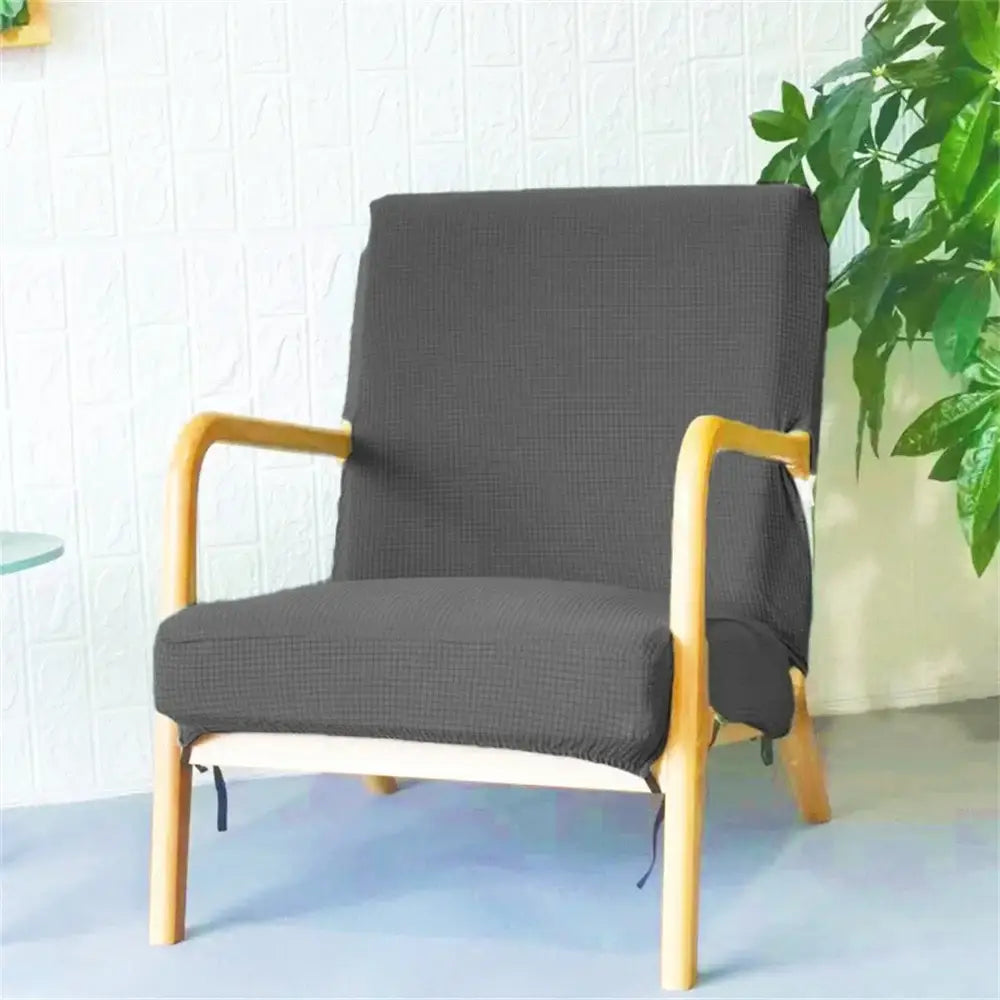 Dark gray textured fabric chair cover snugly fitted over wooden armchair featuring decorbites jacquard elastic seat cover