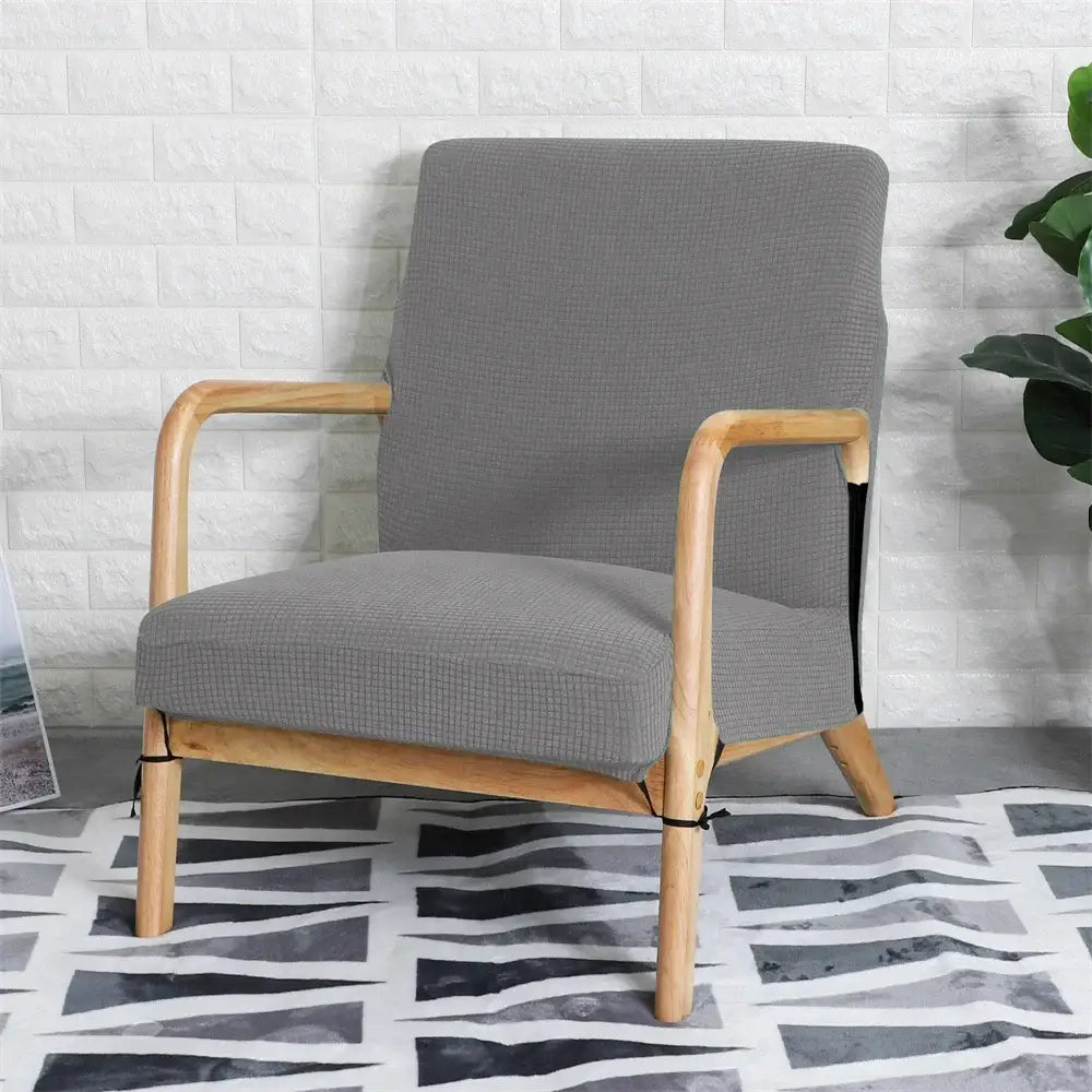 Gray textured fabric armchair with light wood frame featuring decorbites jacquard elastic seat cover for dining room