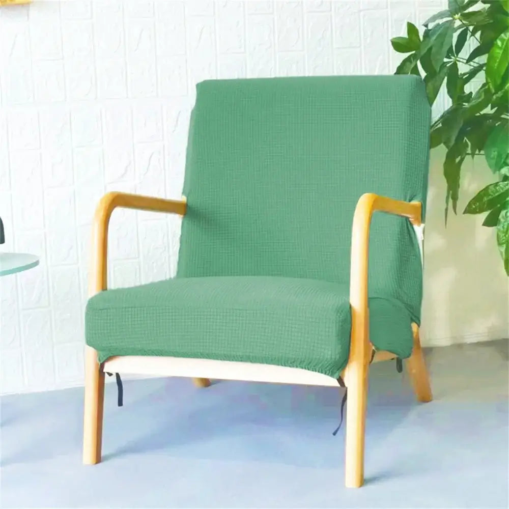 Green textured jacquard elastic seat cover snugly fitted over light wood armchair from decorbites seat covers collection