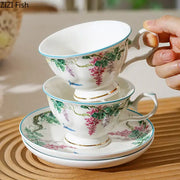 White porcelain green vine flower teacup with pink blossoms gold trim and matching saucer from decorbites green vine set