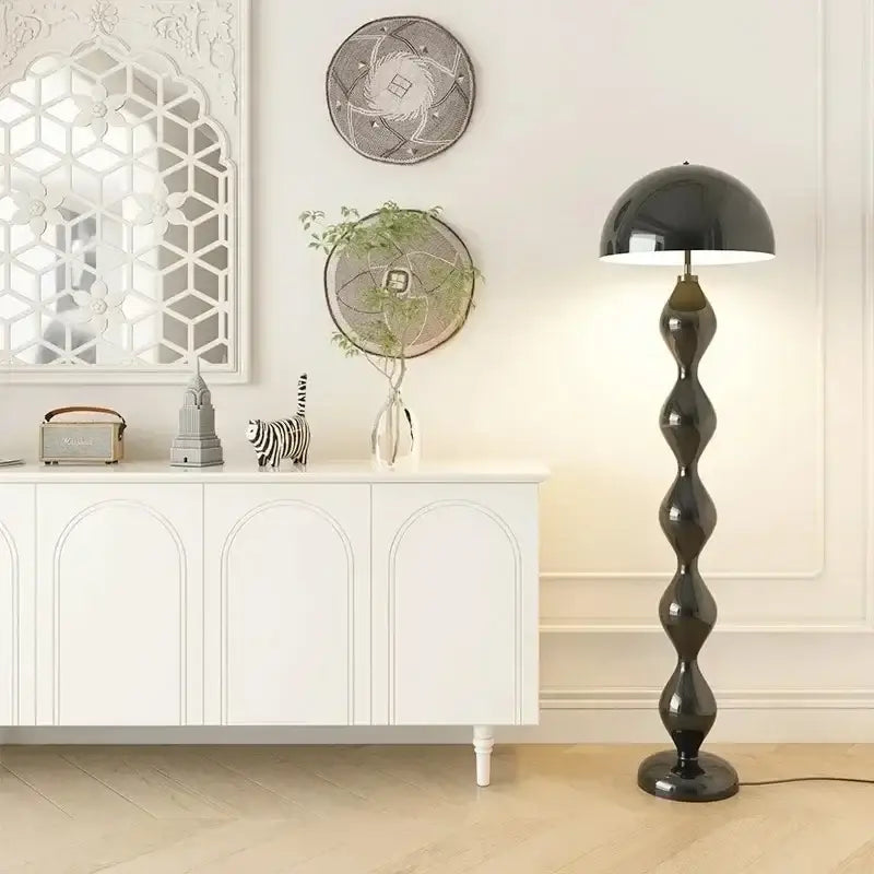 A sleek black decorbites circle mushroom floor lamp with a glossy stacked oval base and domed shade for living room lighting