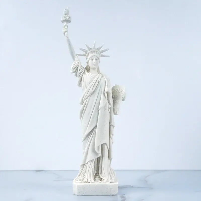 White marble liberty statue model with detailed drapery and raised torch for office desk decor by decorbites