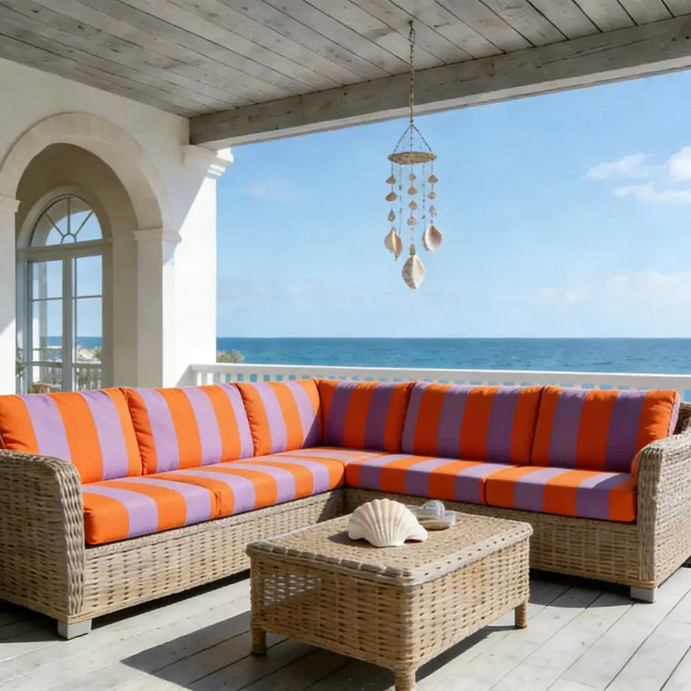 Wicker sectional sofa with orange and purple striped cushions featuring a green and white striped sofa cushion cover protector