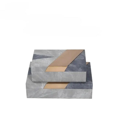 Stacked grey marble pattern leather jewelry container with modern geometric design and gold metallic accents for desktop use