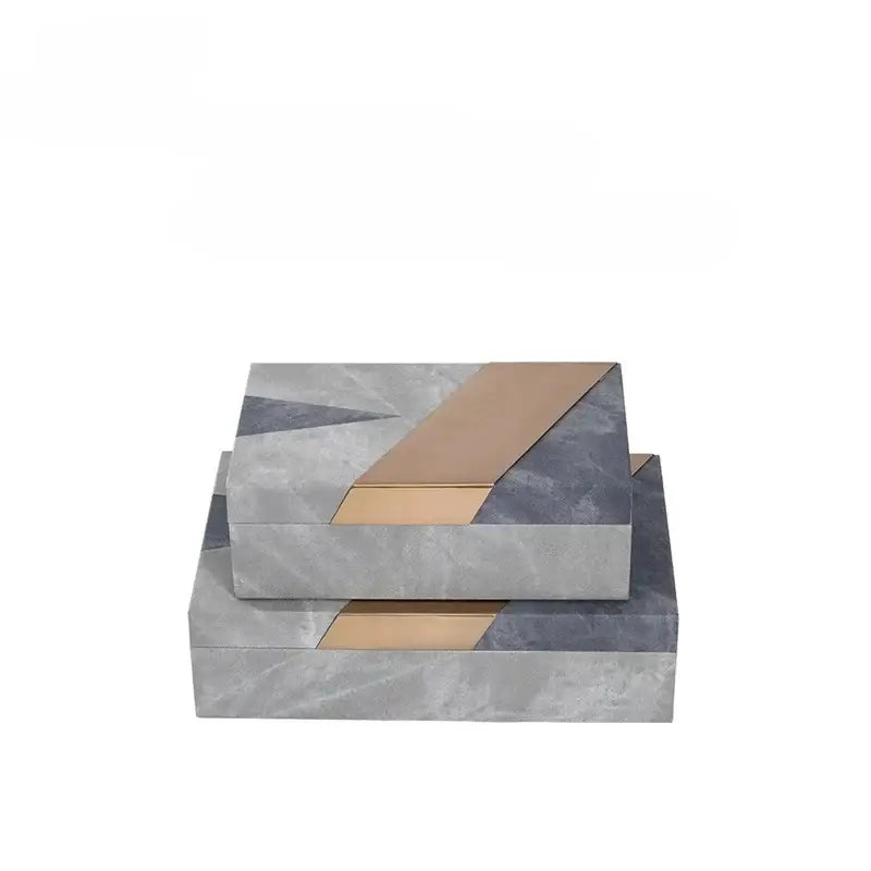 Stacked grey marble pattern leather jewelry container with modern geometric design and gold metallic accents for desktop use