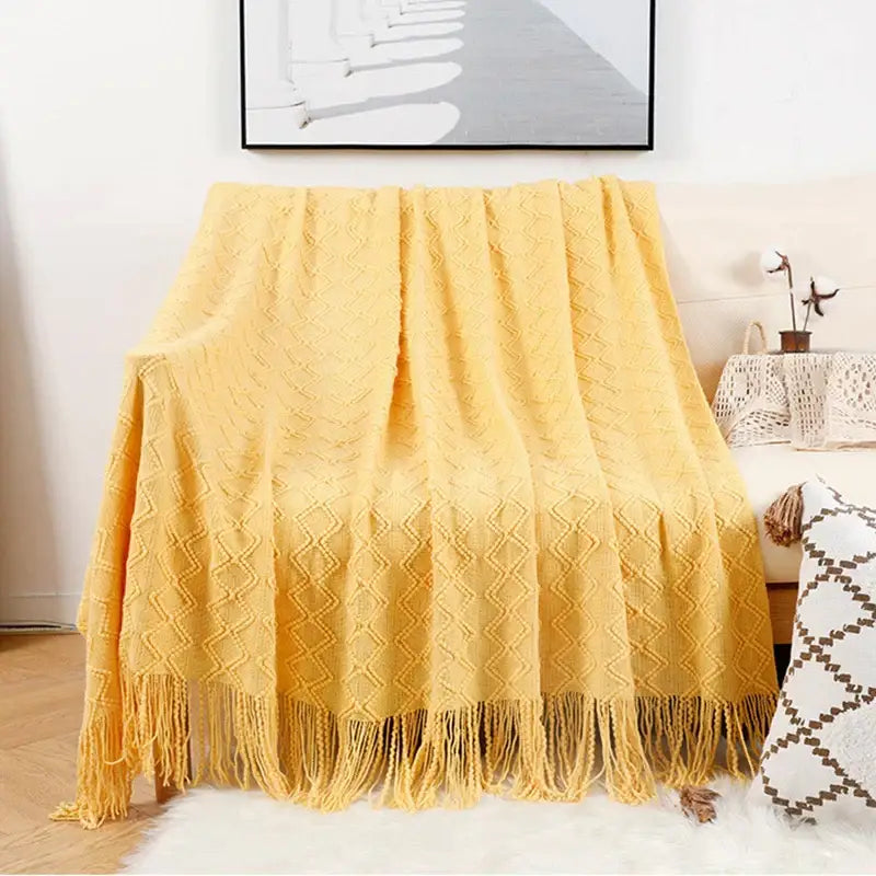 A cozy mustard-yellow knitted throw blanket with diamond-pattern texture and fringe for decorbites grey nordic waffle knit decor