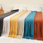 Six colorful knitted throw blankets in nordic waffle knit with diamond patterns including decorbites grey nordic
