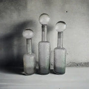 Three textured grey round glass decanters with frosted spherical hammer lid stoppers for living room decorbites decor