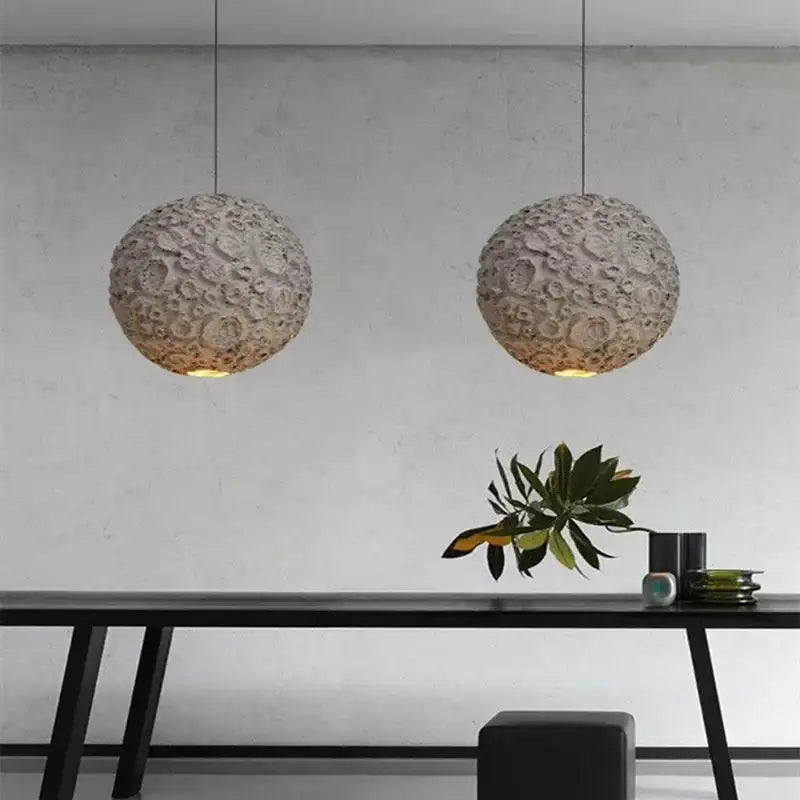 Two spherical off-white matte grey wabi sabi textured pendant lights hang as a wabi sabi chandelier for living room decorbites grey wabi