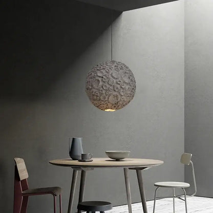 Grey wabi sabi chandelier spherical pendant light with textured lunar crater surface and warm ambient glow for living room decorbites grey wabi