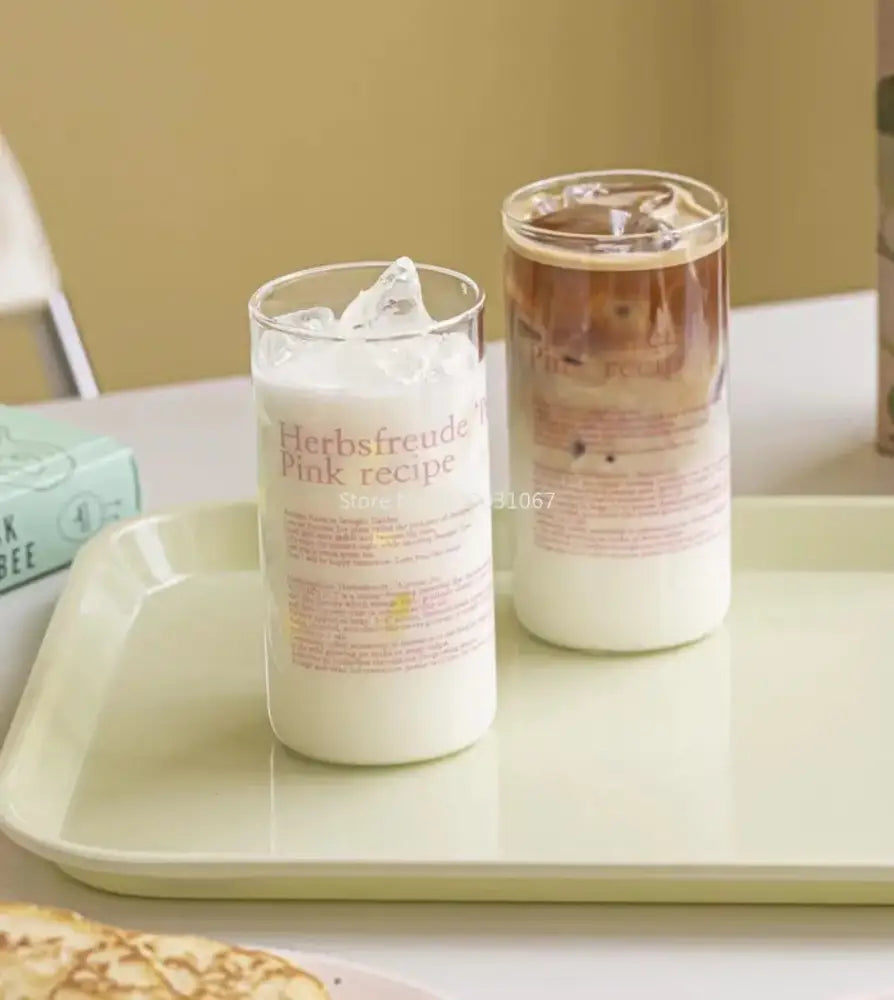 Clear glass coffee cup filled with milk and ice featuring herbsfreude pink recipe label from decorbites glass coffee set