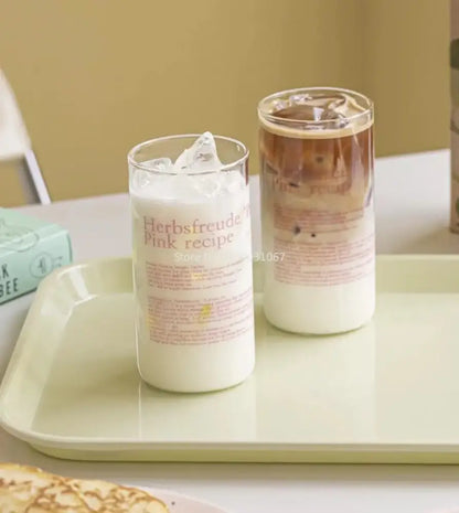Clear glass coffee cup filled with milk and ice featuring herbsfreude pink recipe label from decorbites glass coffee set