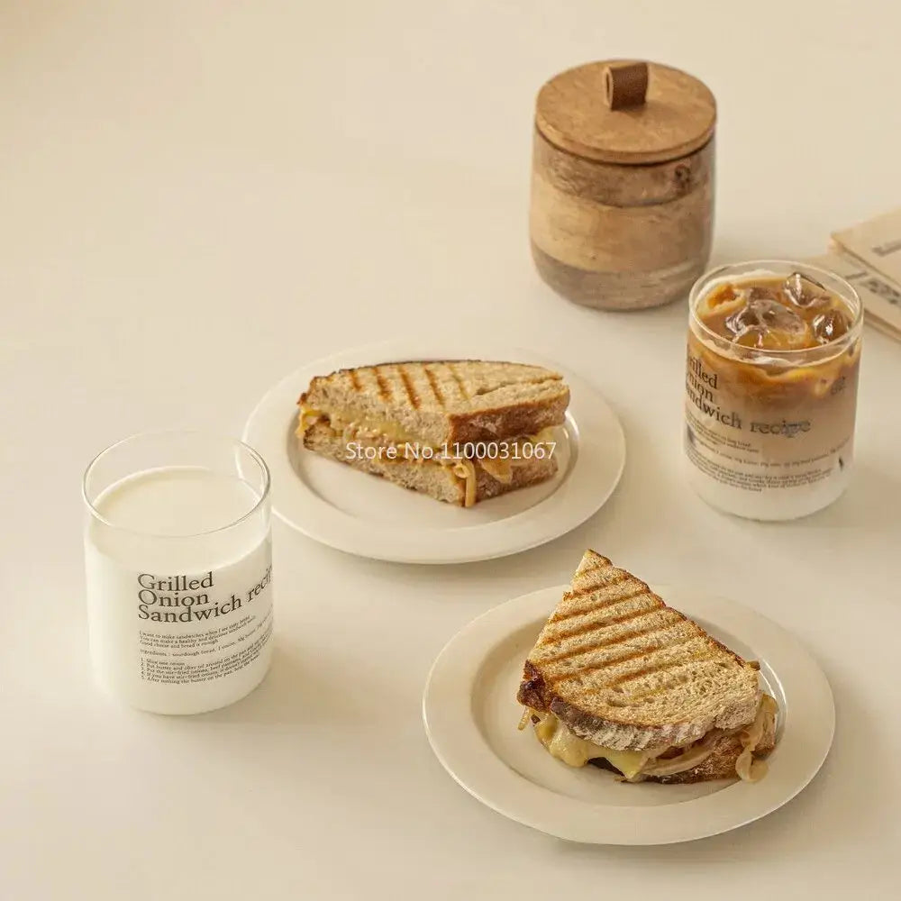 Grilled onion sandwich with melted cheese on white plate paired with decorbites glass coffee cup set kitchen decor