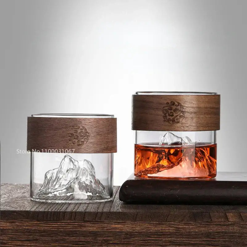 Two clear glass Guanshan hanging ear coffee cups with dark wood lids and engraved design, one with ice for kitchen drinkware