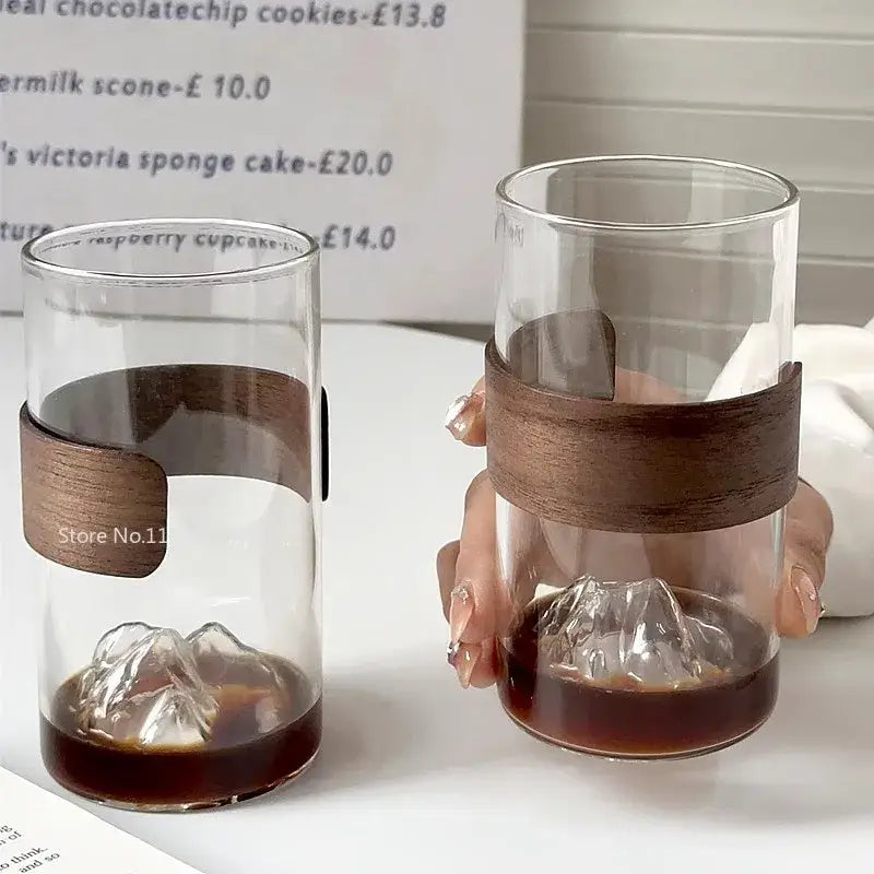 Clear glass coffee cup with dark brown wooden hanging ear band and sculpted mountain base by decorbites guanshan hanging