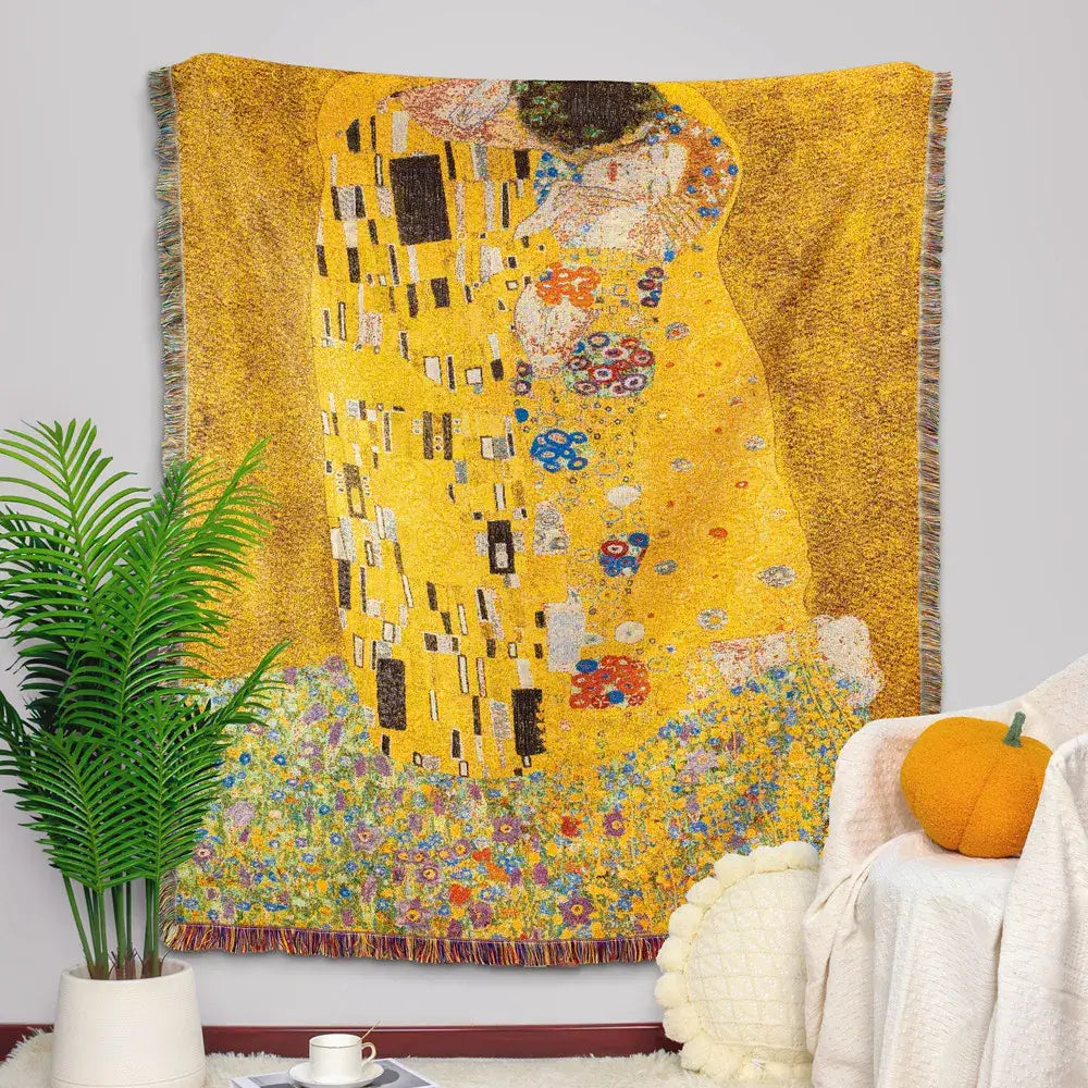 Golden-yellow woven tapestry blanket featuring gustav klimt the kiss art pattern with intricate colorful floral accents