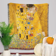 Golden-yellow woven tapestry blanket featuring gustav klimt the kiss art pattern with intricate colorful floral accents