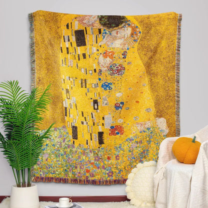 Golden-yellow woven tapestry blanket featuring gustav klimt the kiss art pattern with intricate colorful floral accents