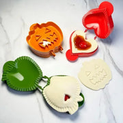 Set of colorful halloween-themed hand pie molds in orange red and green plastic for kitchen baking tools