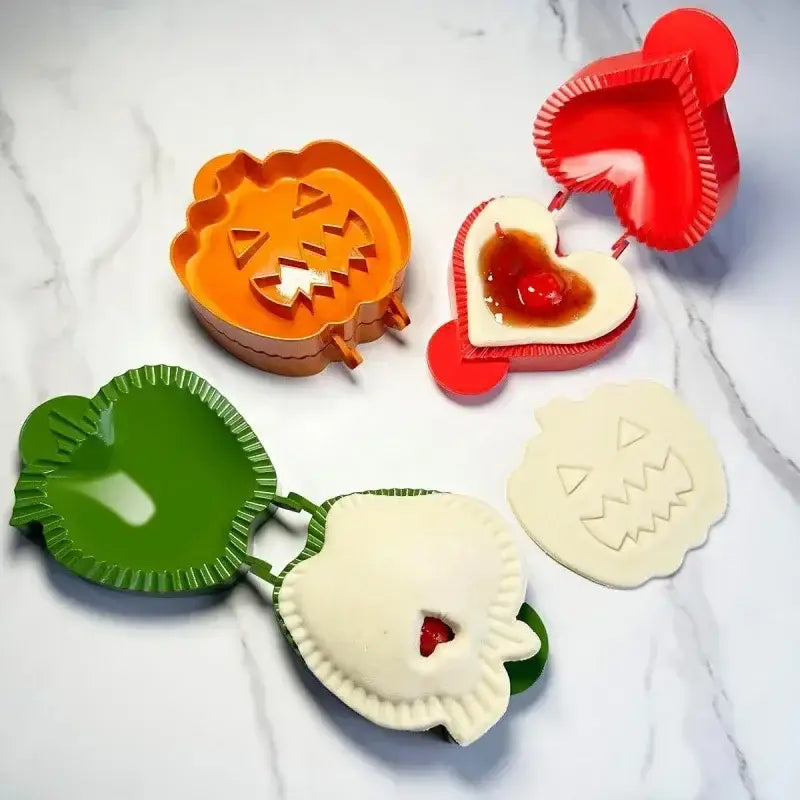 Set of colorful halloween-themed hand pie molds in orange red and green plastic for kitchen baking tools