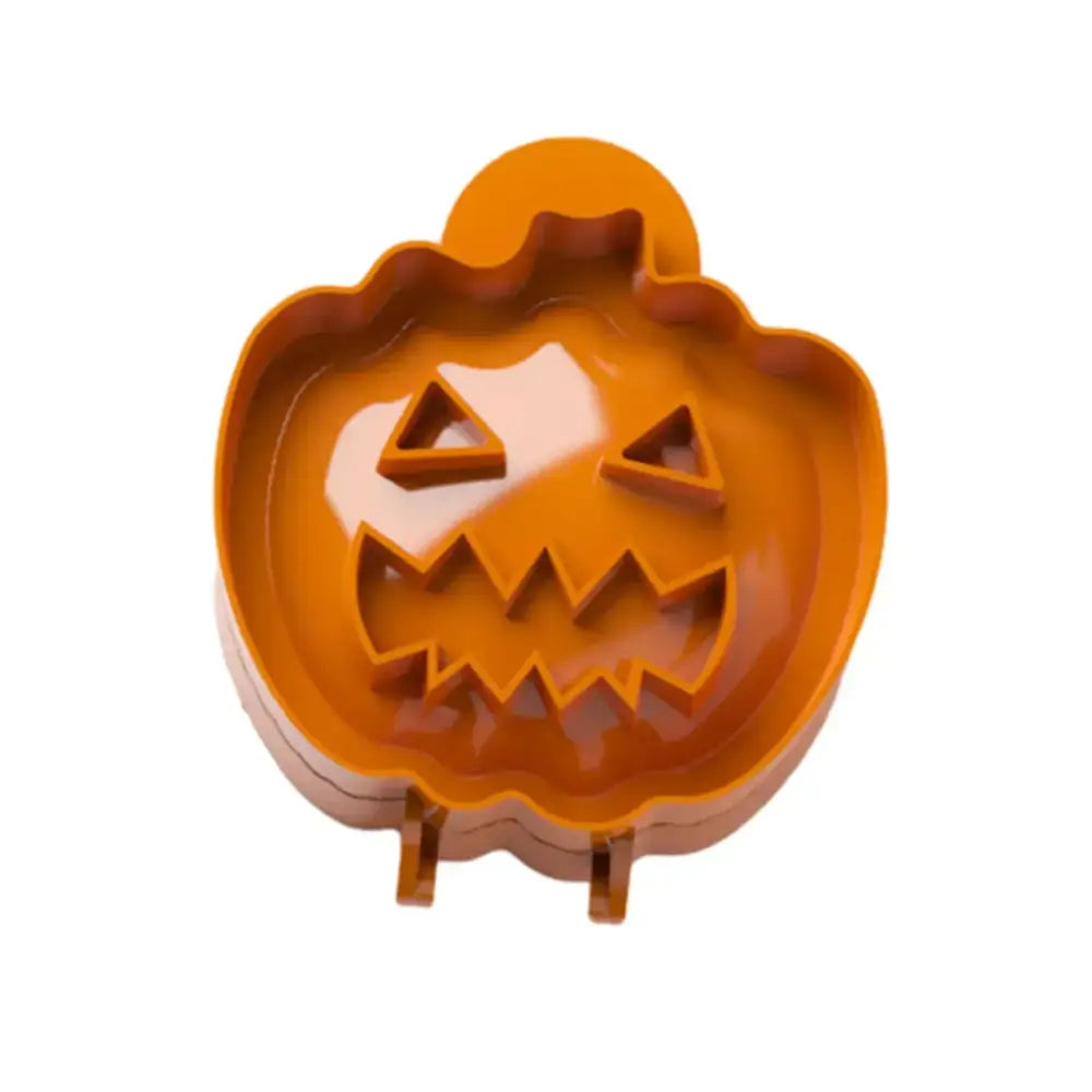 Orange plastic halloween pumpkin hand pie mold with triangular eyes and jagged teeth in a pie molds set for baking