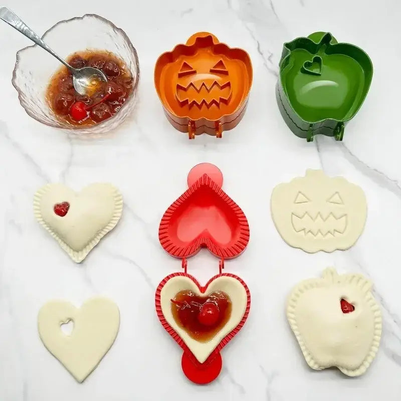 Orange pumpkin-shaped hand pie mold with smiling face design and red accents from halloween pie molds set for baking tools