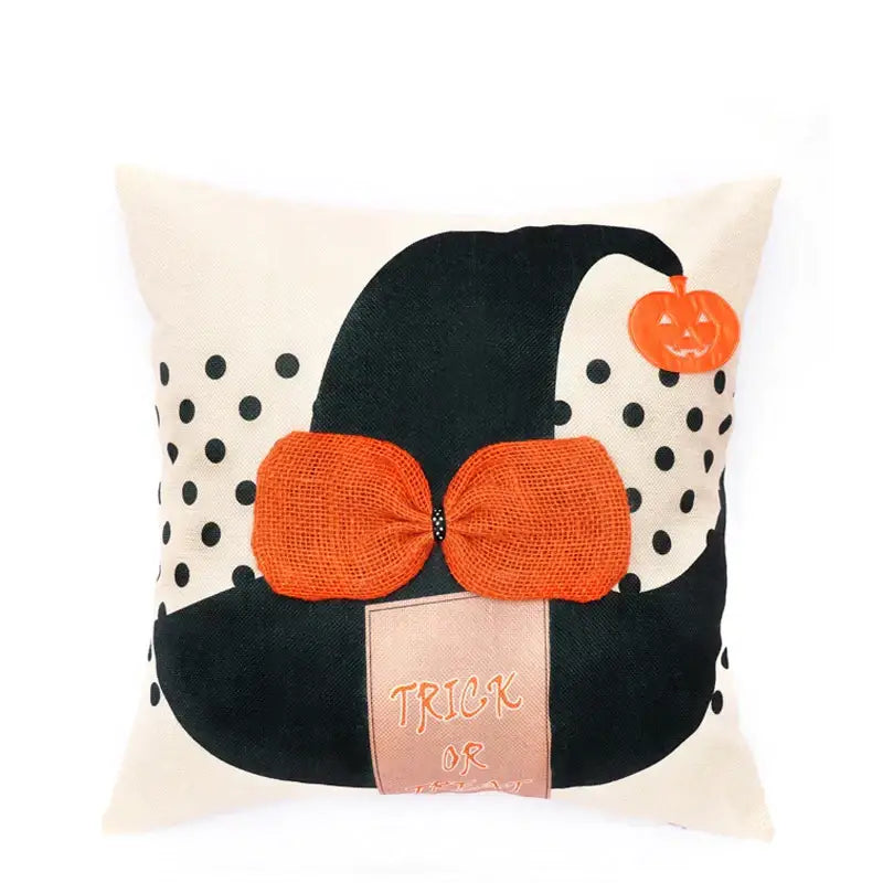 Cream-colored pillow cover featuring halloween wizard hat with spider embroidered, orange burlap bow, and pumpkin charm