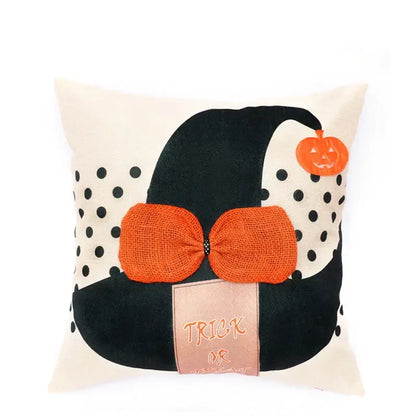 Cream-colored pillow cover featuring halloween wizard hat with spider embroidered, orange burlap bow, and pumpkin charm