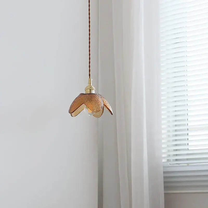 Delicate hammered amber glass led pendant light with textured petal design and brass hardware for kitchen use