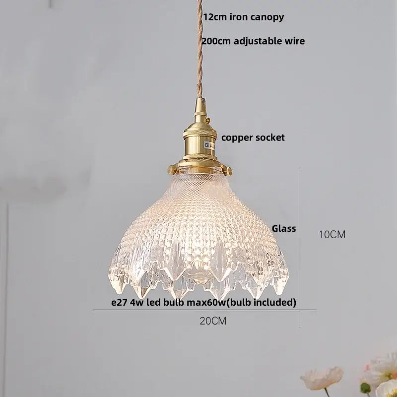 A 10cm tall hammered amber glass led pendant light with textured faceted design and brass fittings for kitchen use