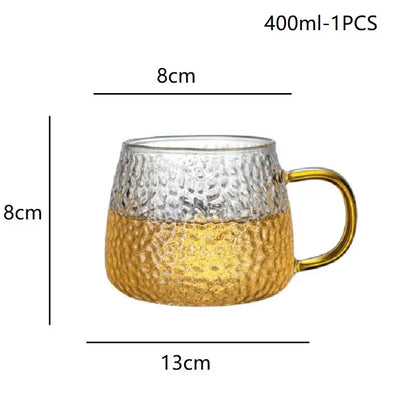 Hammered clear glass water cup with gold handle featuring a clear and gold hammered glass mug design