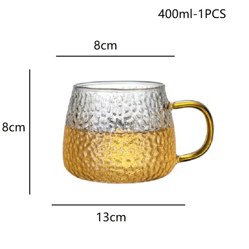 Hammered clear glass water cup with gold handle featuring a clear and gold hammered glass mug design