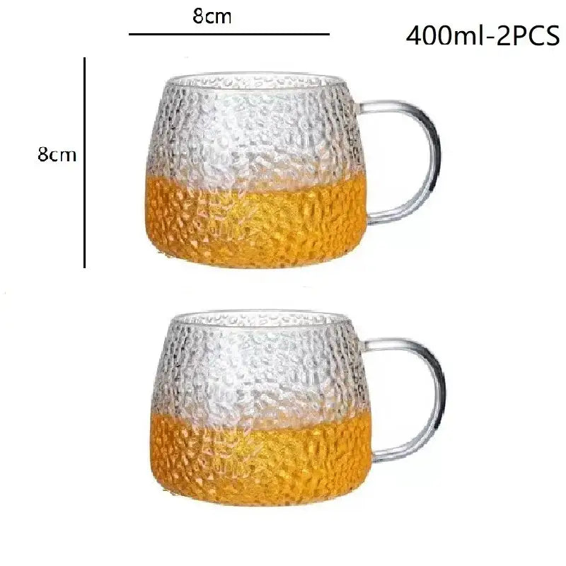 Hammered clear glass water cup with textured amber lower half and gold handle for elegant glass water use