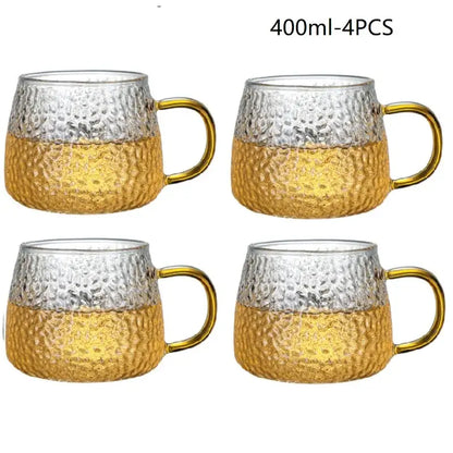 Set of four 400ml hammered clear glass water cups with gold lower halves and golden handles for kitchen use